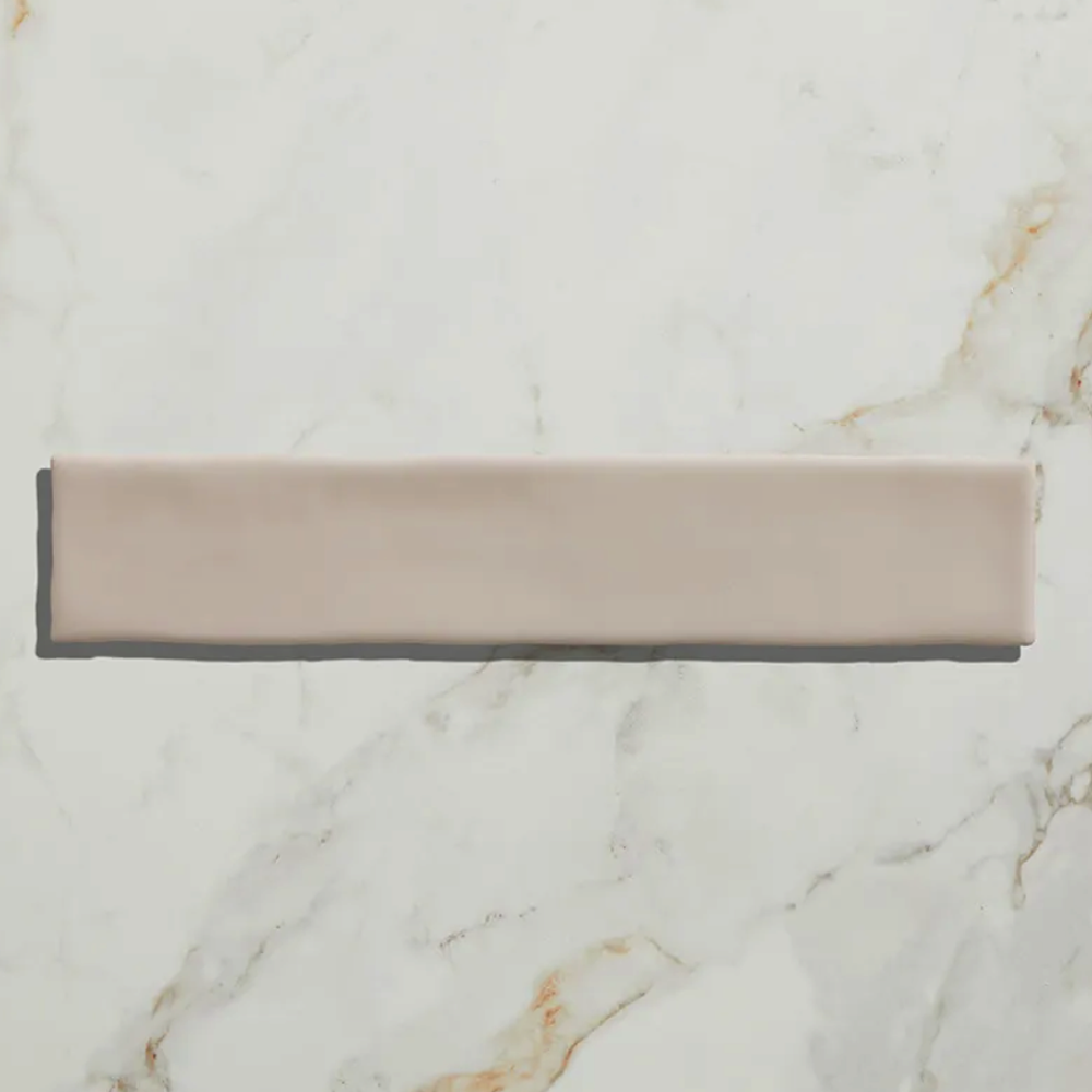 Rectangular tile with a beige and gray gradient on a marble background plaster