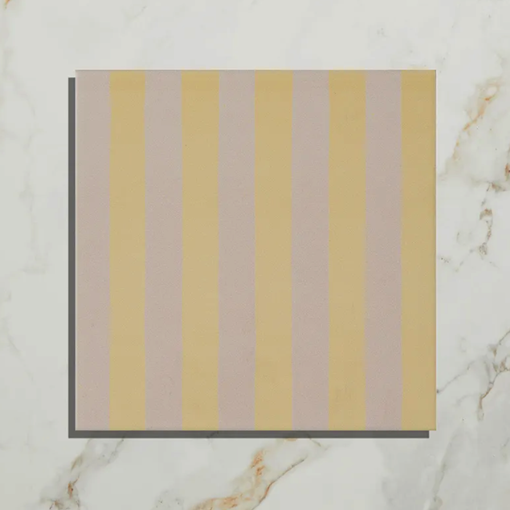 Striped fabric swatch with yellow and beige stripes on a marble background