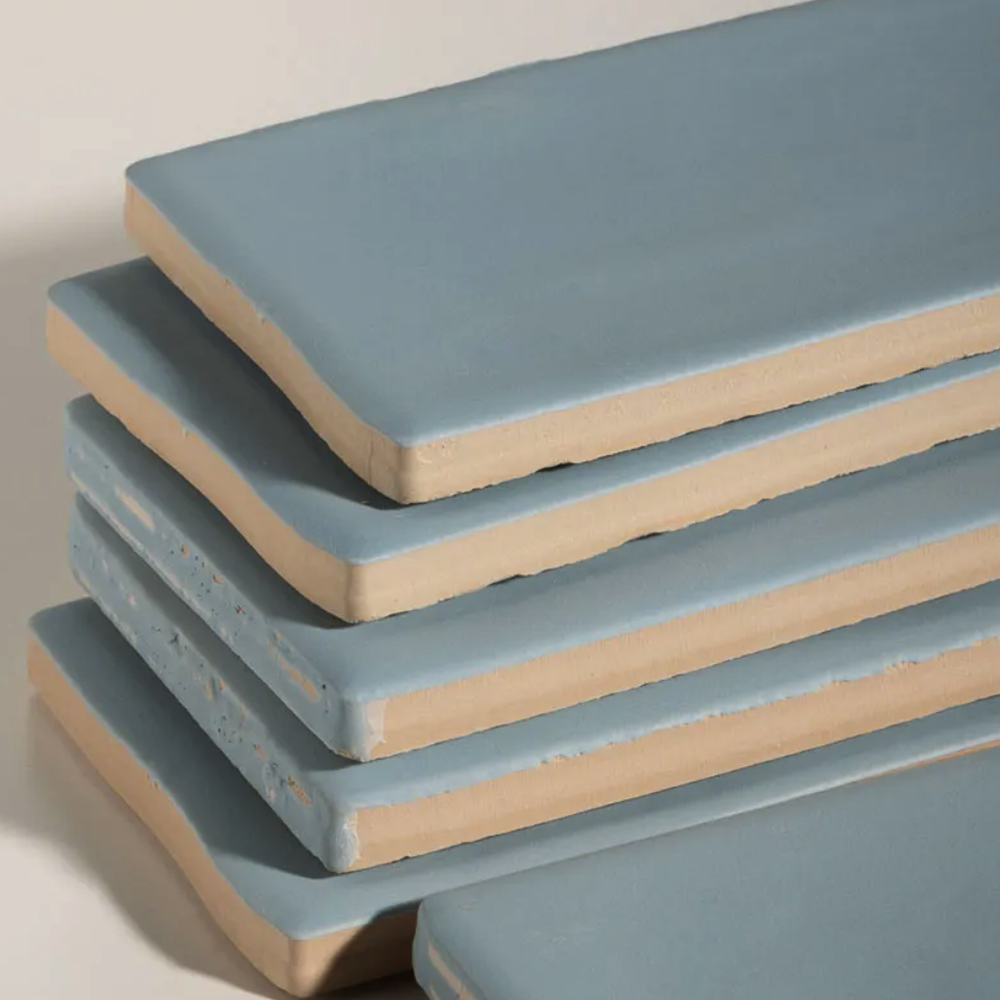 Stack of blue foam mats on a light background