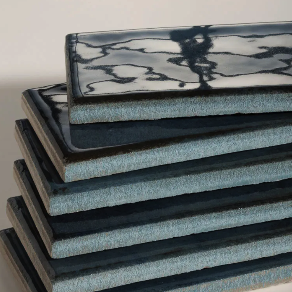 Stack of blue foam mats on a light background