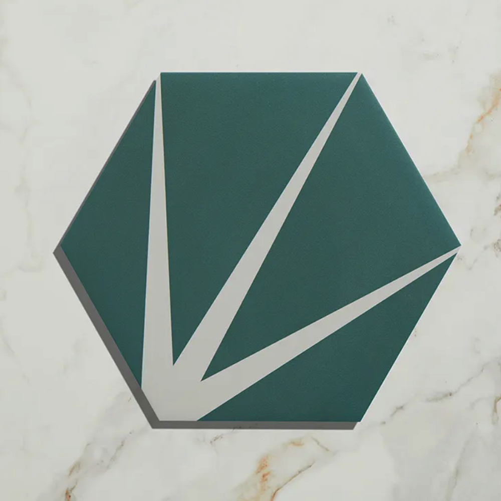 Hexagonal green tile with white accents on a marble surface