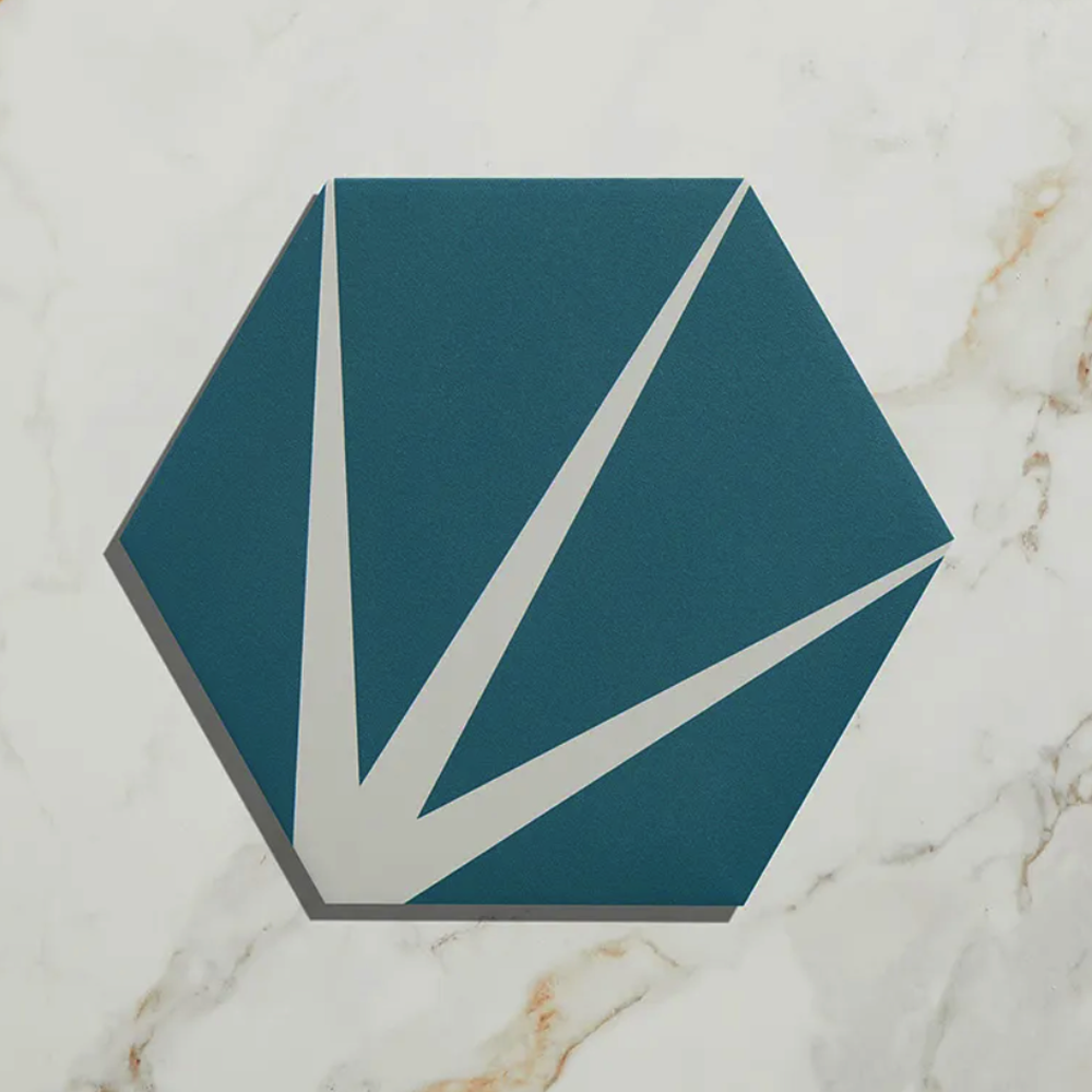 Hexagonal teal tile with white accents on a marble background