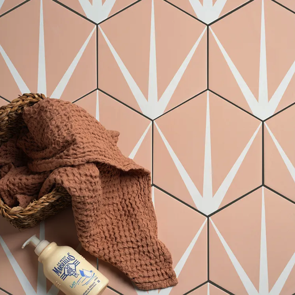 Brown textured towel and bottle on a geometric patterned floor