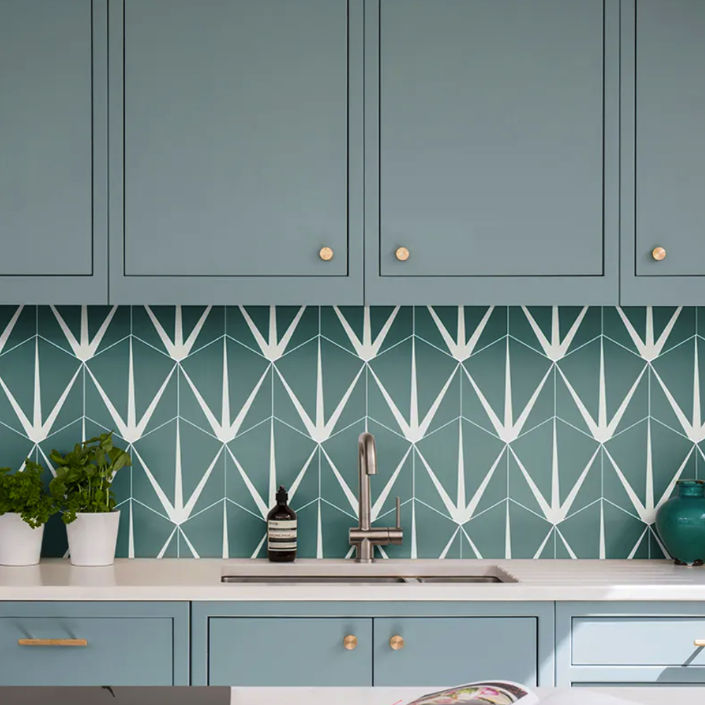 Kitchen with teal cabinets and geometric patterned backsplash