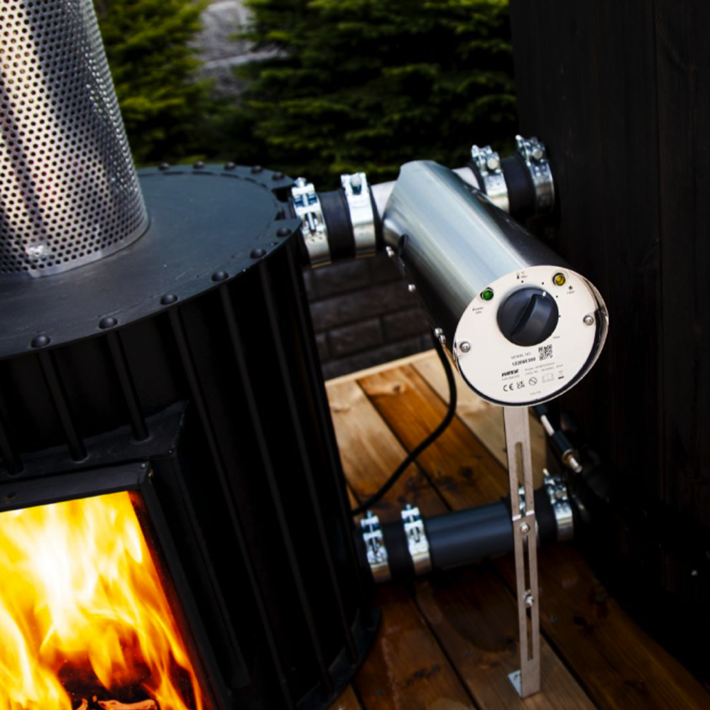 Wood-burning stove with a control panel on a wooden deck