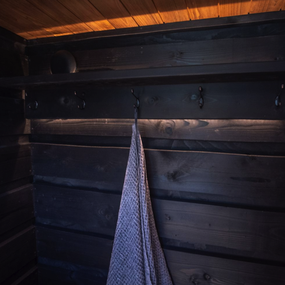 Towel hanging on a hook in a wooden sauna