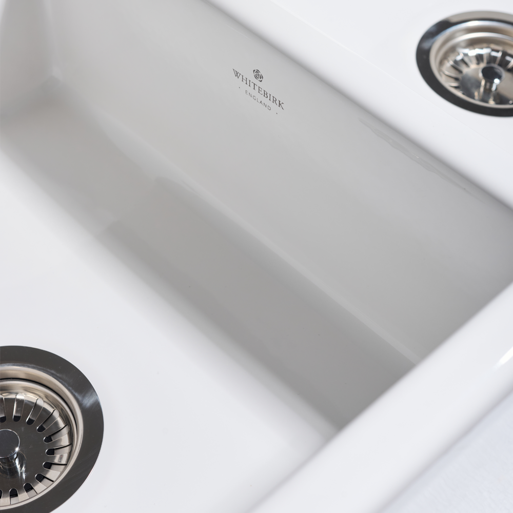 Close-up of a stainless steel kitchen sink with Whiterock branding.