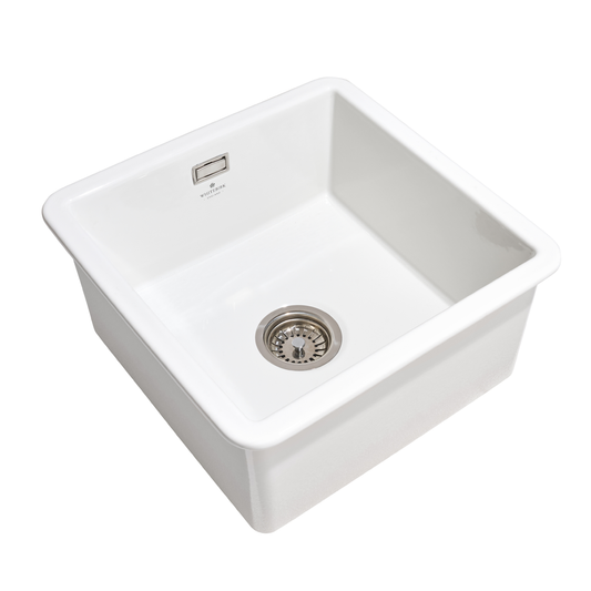 White kitchen sink with drain on a white background