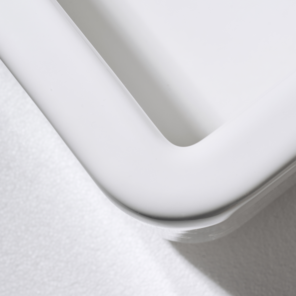 Close-up of a white toilet seat on a light gray background