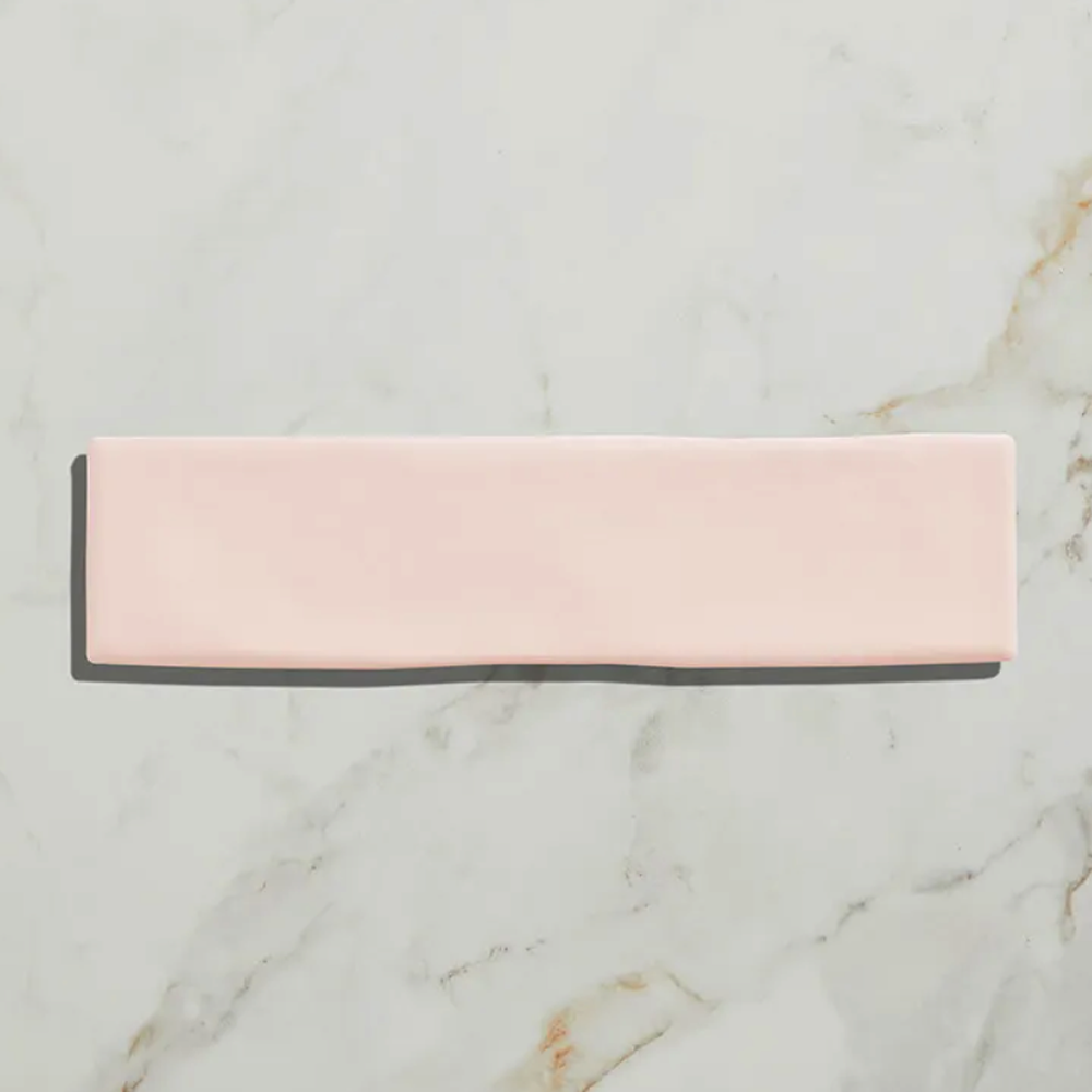Rectangular pink and gray bar on a marble surface