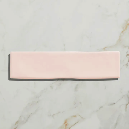 Rectangular pink and gray bar on a marble surface