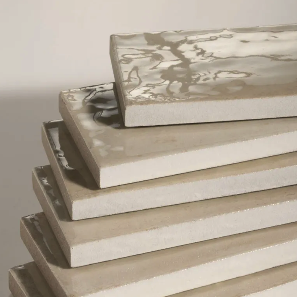 Stack of rectangular ceramic trays with floral patterns on a neutral background