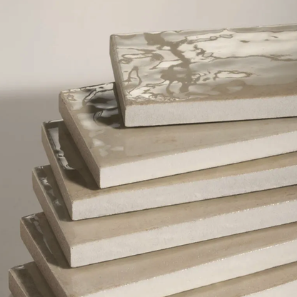 Stack of rectangular ceramic trays with floral patterns on a neutral background