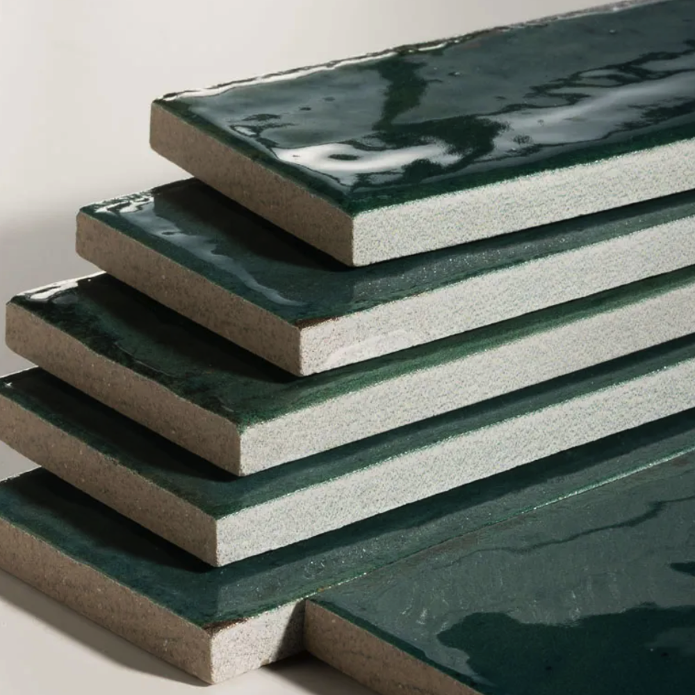 Stack of green ceramic tiles on a light background
