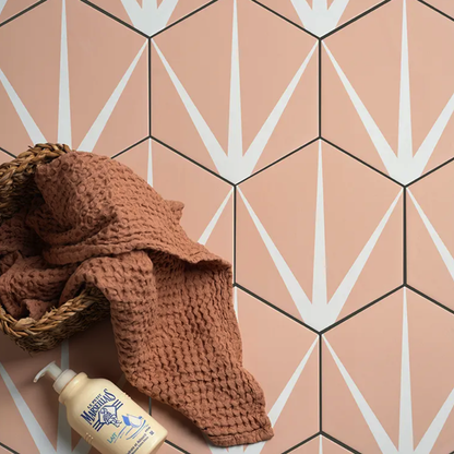 Brown textured towel and bottle on a geometric patterned floor