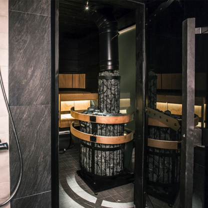 Modern steam room with stone interior and wooden benches.