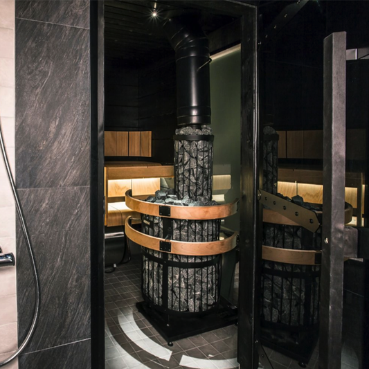 Modern steam room with stone interior and wooden benches.