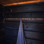 Towel hanging on a hook in a wooden sauna