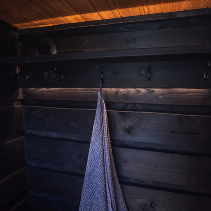 Towel hanging on a hook in a wooden sauna