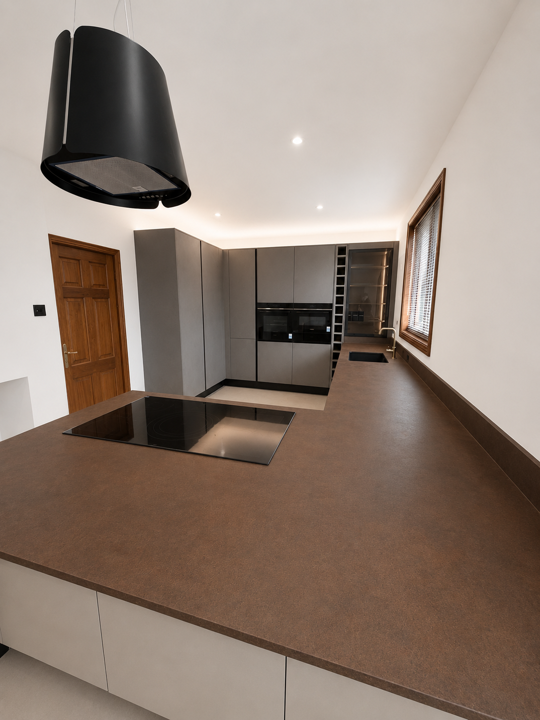 Liquid Metal Iron worktop with induction hob and stone-grey tall units