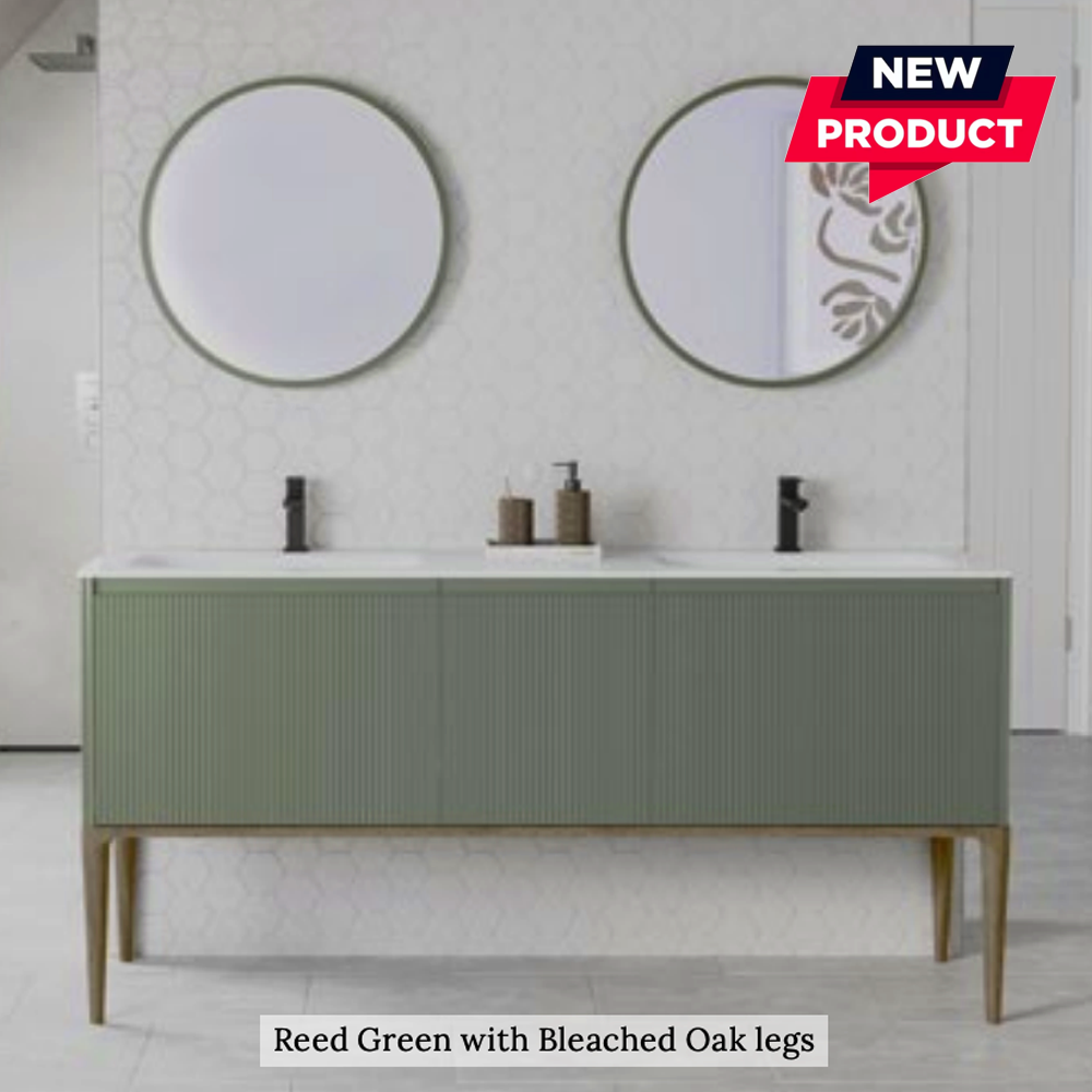 Bathroom vanity with round mirrors, soap dispensers, and bottles on a light gray wall.