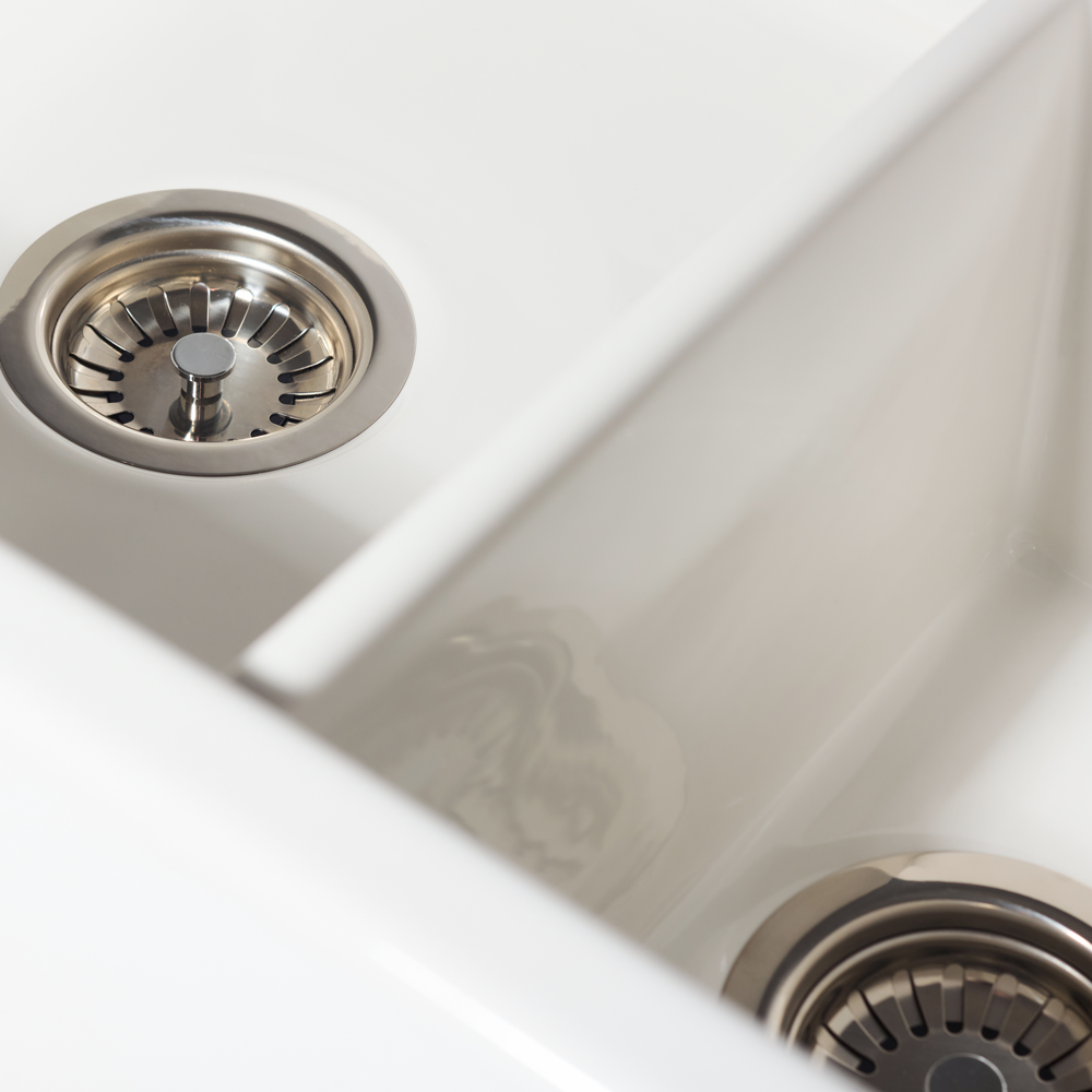 Close-up of a stainless steel kitchen sink with drain holes.