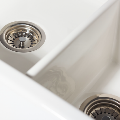 Close-up of a stainless steel kitchen sink with drain holes.