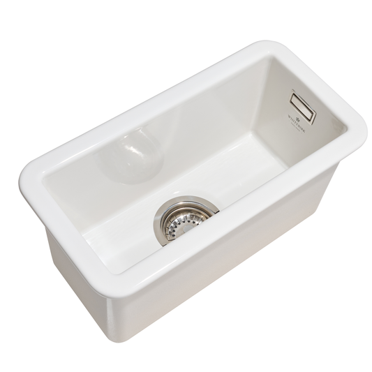 White kitchen sink with a drainboard on a white background