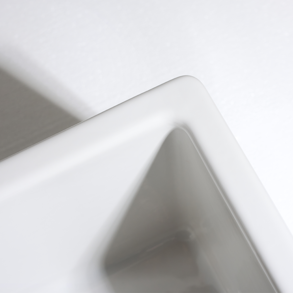 Close-up of a white ceramic bowl with a gray interior on a light gray background