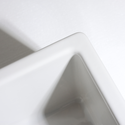 Close-up of a white ceramic bowl with a gray interior on a light gray background