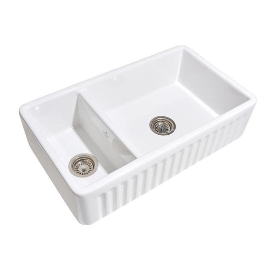 White ceramic kitchen sink with two drainholes on a white background