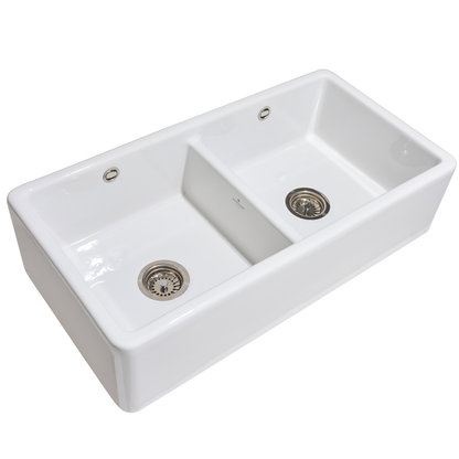White ceramic kitchen sink with two basins on a white background