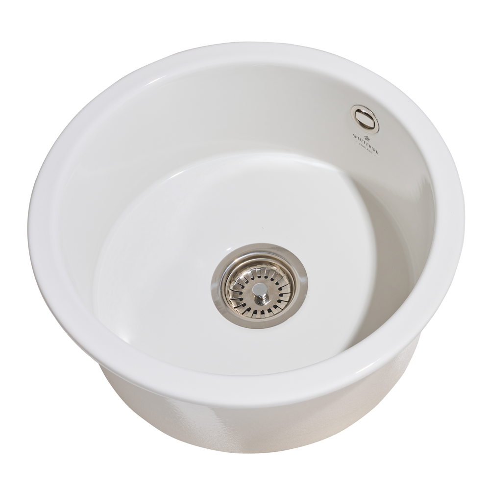 White ceramic sink with a drain on a white background