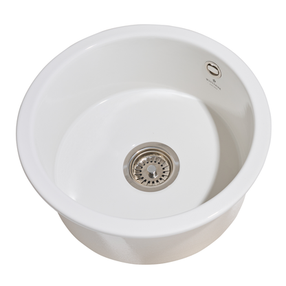 White ceramic sink with a drain on a white background