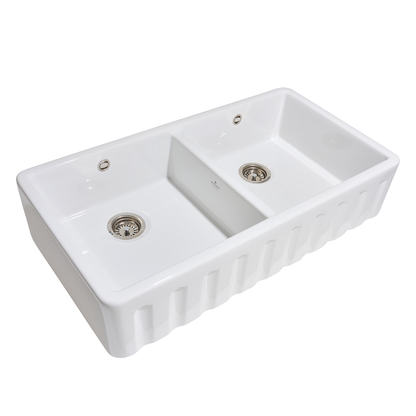 White ceramic double-basin kitchen sink on a white background