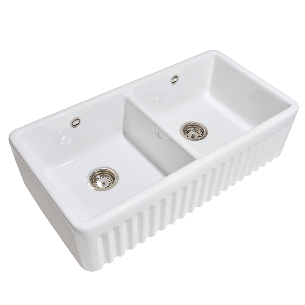 White ceramic kitchen sink with two basins on a white background