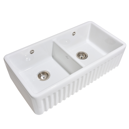 White ceramic kitchen sink with two basins on a white background