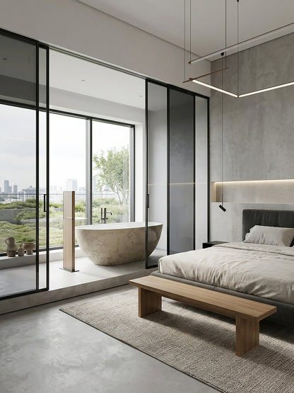 Microcement freestanding bath in an open-plan modern bedroom suite with city view